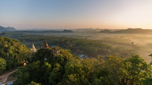 Time lapse Aerial view of Khao Na Nai pagoda stupa. Luang Dharma Temple Park with green mountain hills and forest trees, Surat Thani, Thailand. Thai buddhist temple archtecture. Tourist attraction
