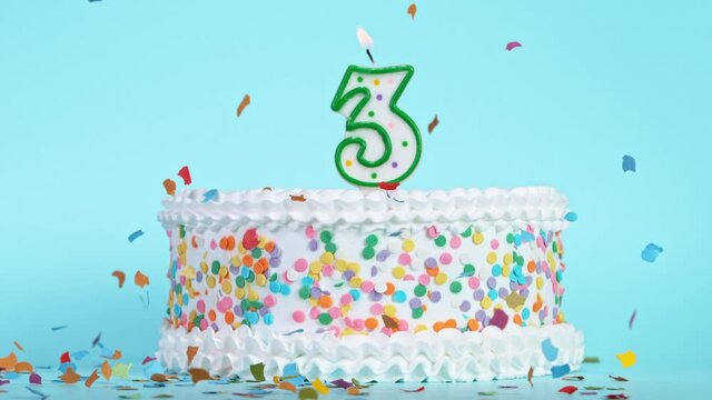 Birthday Cake With Burning Colorful Candle with Number 3 on Pastel Background. Falling confetti. Super Slow Motion, 1000 FPS.