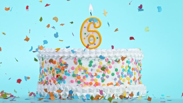 Birthday Cake With Burning Colorful Candle with Number 6 on Pastel Background. Falling confetti. Super Slow Motion, 1000 FPS.