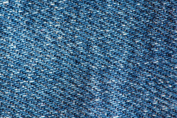 Denim old blue jeans fabric close up. Textured background or wallpaper