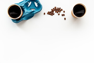 Paper coffee cups with coffee beans. Top view
