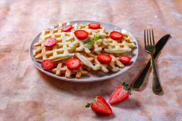 Homemade belgian waffles with strawberries.