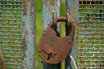 Old rusty padlock on the old rusty gates © Aleksei