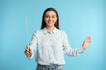 Music teacher with baton on turquoise background