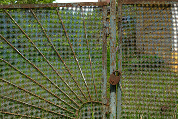 Old rusty padlock on the old rusty gates © Aleksei