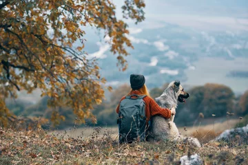 Fotobehang woman hiker next to dog friendship nature mountains travel © SHOTPRIME STUDIO