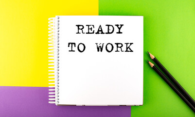 Minimal work space : sketchbook on the colorful background with READY TO WORK text