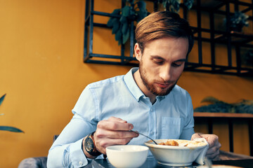 Fototapeta na wymiar business man in blue shirt having lunch at a cafe table