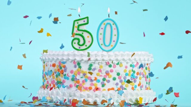 Birthday Cake With Burning Colorful Candles with Number 50 on Pastel Background. Falling confetti. Super Slow Motion, 1000 FPS.