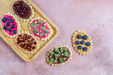 Homemade desserts with blueberries,kiwi slices and pomegranate seeds.