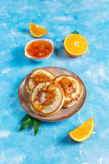 Homemade american pancakes with orange fruits.