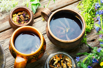 Mugs of herbal tea with various herbs
