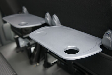 Plastic folding tables in the passenger compartment of the minibus. - 436630307