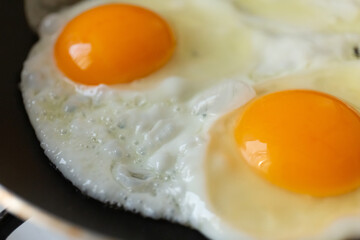 close-up of fried eggs in a pan