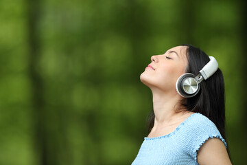 Asian woman breathing listening music with headphones