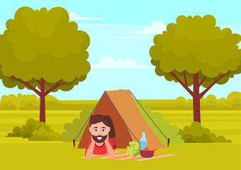 Fototapeta na wymiar Tourist camping with tent in forest. Young man lies on blanket near plate with vegetables and bottle. Male traveler smiling and resting in nature. Person leads an active lifestyle spends time outdoors
