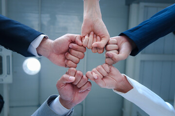 Businessman and woman putting hands fist join together, business partnership colleagues holding...