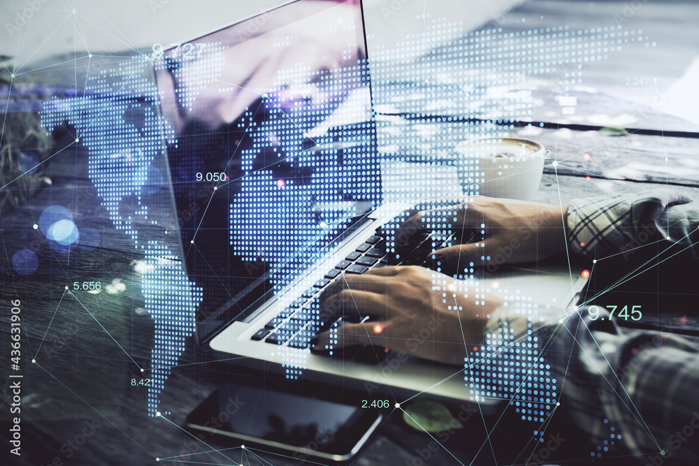 Poster Global business and technology concept. Side view and close up of hands at desktop using laptop with glowing digital map. Double exposure.