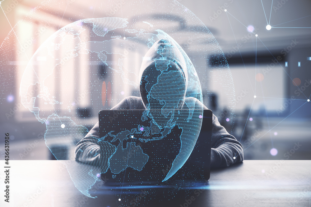 Aufkleber Hacker using laptop with digital globe in blurry office interior. Hacking, malware and cloud computing concept. Double exposure.