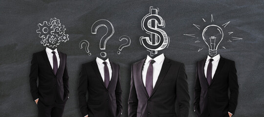 Idea and financial development concept. Headless businessmen in suits standing on chalkboard background with symbol scribbles.
