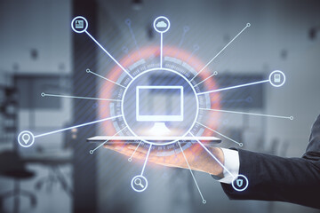 Encircled computer icon with a hand holding the tablet in the background, online business and and education concept. Double exposure