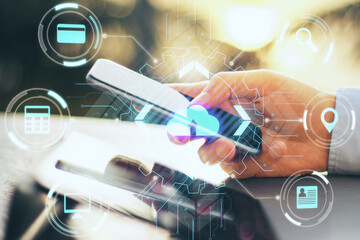 Close up of hand using smartphone with abstract glowing cloud computing concept hologram on blurry background. Double exposure.