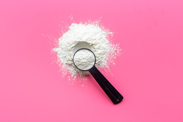 White whey protein powder in scoop. Sport nutrition concept