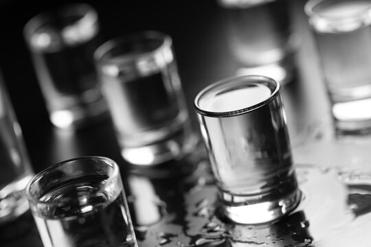 Bottle of vodka and in a shot glass close-up.