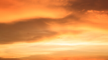 Background of orange sky and clouds with sunset light in evening at summer time when with blank copy space, showing about environment, climate concept.