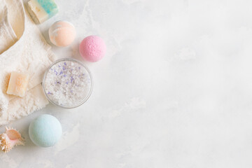 Obraz premium A set of cosmetics for taking a bath on a gray background. View from above. Copy space. Banner