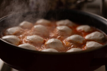 meatballs are prepared in tomato sauce in the home kitchen