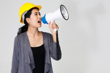 Female builder shouting in megaphone in studio