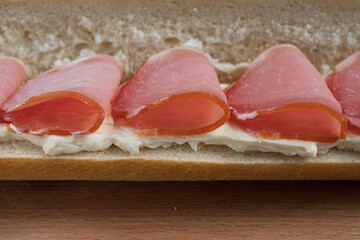 Bacon slices stacked on a sandwich baguette
