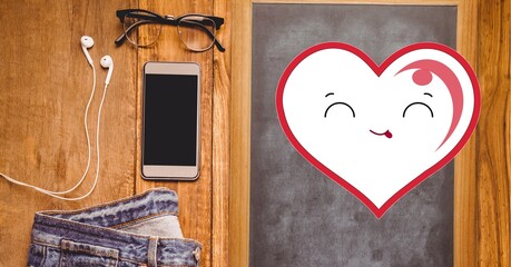 Composition of smiling heart with glasses, jeans, smartphone and earphones on wooden surface
