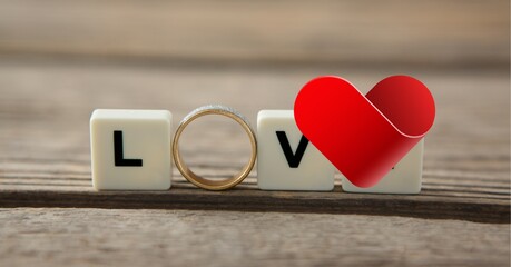 Composition of heart, weeding ring and love text on white squares