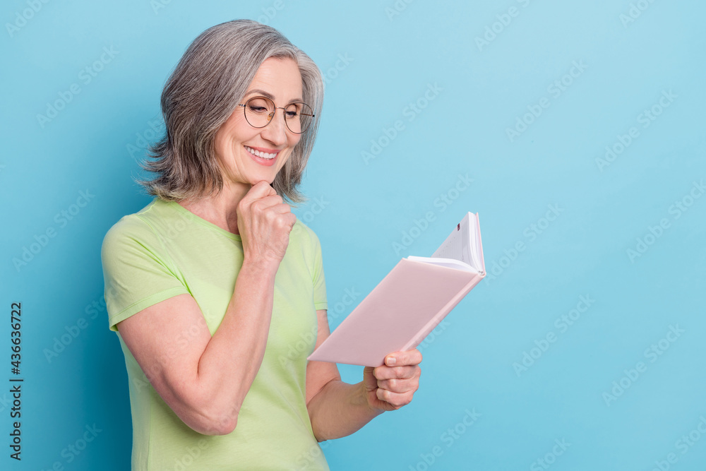 Sticker Photo of charming old smart woman look book think wear glasses smile isolated on pastel blue color background