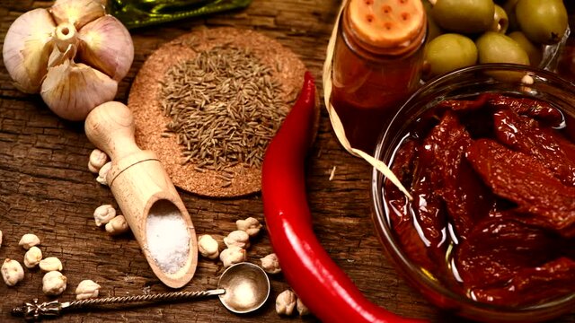 Various herbs and spices for hummus on wooden background. 4K UHD video footage 3840X2160.