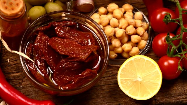 Various herbs and spices for hummus on wooden background. 4K UHD video footage 3840X2160.