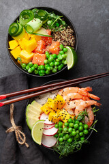 Poke bowls with shrimps, salmon, avocado and mango