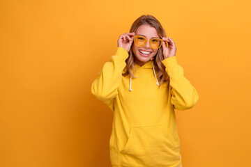 Obraz na płótnie Canvas young pretty blonde woman cute face expression posing in yellow hoodie