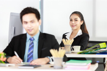 Asian businessman and businesswoman working together in office. Concept for teamwork in company