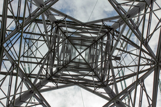 Dead centre view into HV pylon mast - stock photo