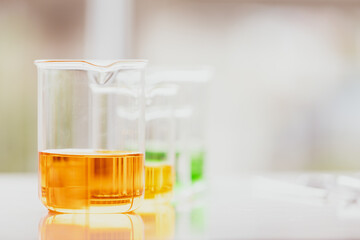 Colorful water and liquid in beager and test tube in laboratory.