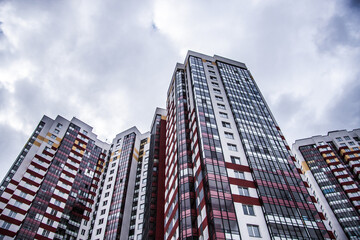 Fototapeta premium residential complex with high-rise buildings against a cloudy sky 