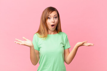 pretty adult woman feeling extremely shocked and surprised