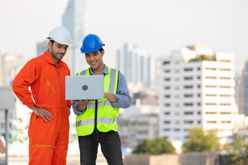 technician or engineer using laptop computer on the top of the roof