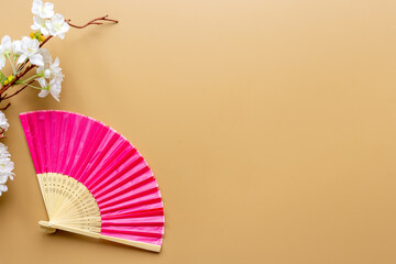 Asian background with hand fan and blossom branches