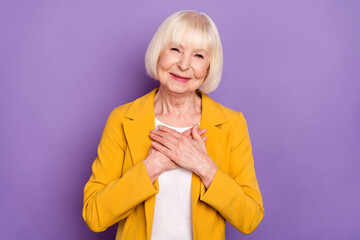 Portrait of satisfied aged person arms palms on chest look camera isolated on purple color background