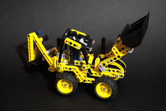 toy yellow excavator on a black background