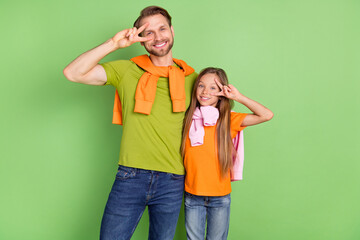 Portrait of attractive cheerful people dad daddy showing v-sign having fun good mood isolated over green color background